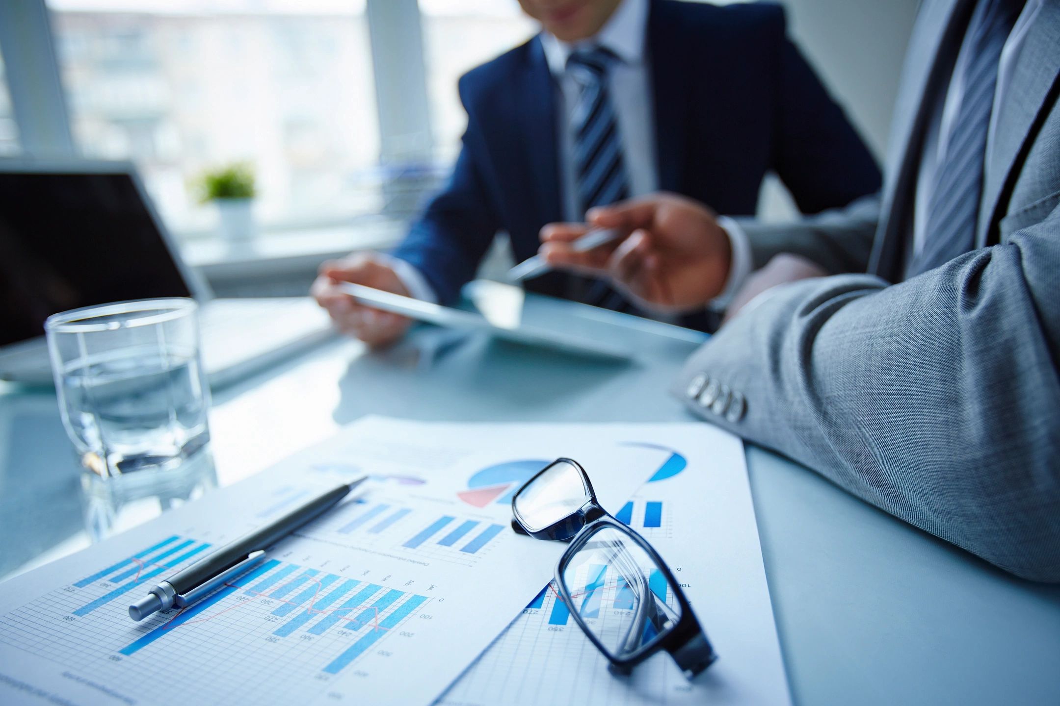 Business meeting with documents and glasses on the table.